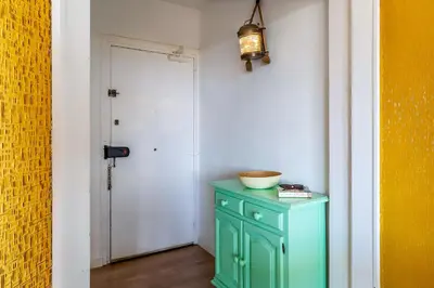 a room with a green cabinet and a door at Canela Homes COSTA CASTELLDEFELS in Castelldefels