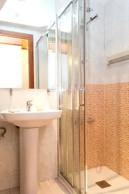 a bathroom with a sink and a shower at Apartment Bright Sagrada Familia in Barcelona