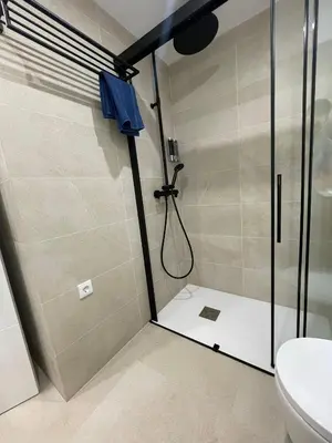 a bathroom with a shower and a toilet at YOUR HOME - Camp Nou Apartment in Hospitalet de Llobregat