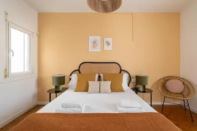 a bedroom with a large bed and two chairs at Stay U-nique Apartments Gaudi III in Barcelona