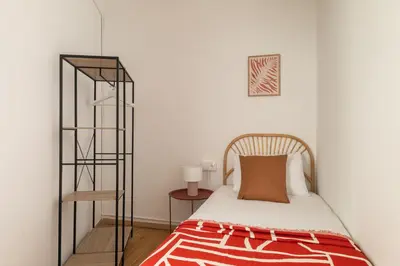 a small bedroom with a bed and a book shelf at Stay U-nique Apartments Gaudi III in Barcelona