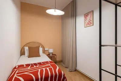a bedroom with a bed with a red and white blanket at Stay U-nique Apartments Gaudi III in Barcelona