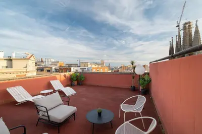 a patio with chairs and tables on a balcony at Stay U-nique Apartments Gaudi III in Barcelona