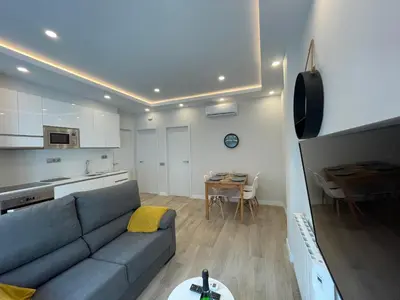 a living room with a blue couch and a table at manresa universidad in Manresa