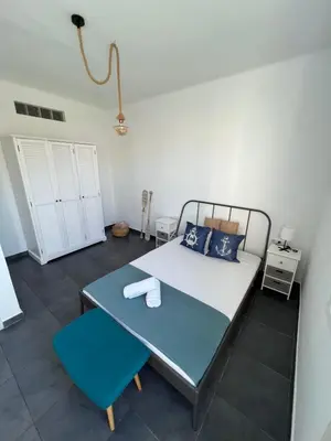 a bedroom with a bed and a blue chair at Apartments near Ramblas - Only for stays over 32 days in Barcelona