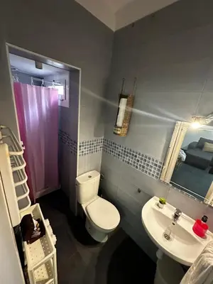 a small bathroom with a toilet and a sink at Apartments near Ramblas - Only for stays over 32 days in Barcelona