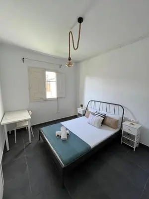 a bedroom with a bed and a window at Apartments near Ramblas - Only for stays over 32 days in Barcelona