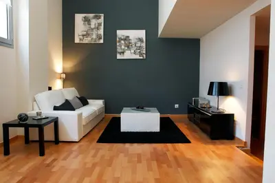 a living room with a white couch and a table at Fira Duplex in Hospitalet de Llobregat