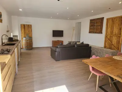 a living room with a couch and a table at Villa Urbina in Olerdola