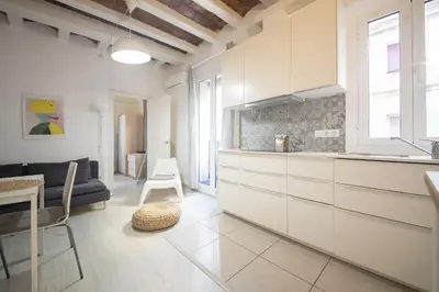 a kitchen and living room with white cabinets at Catalunya Casas Lovely apartment central Barcelona 100m to beach! in Barcelona