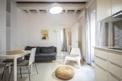 a living room with a couch and a table at Catalunya Casas Lovely apartment central Barcelona 100m to beach! in Barcelona