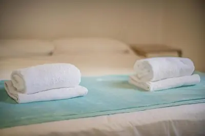 two towels sitting on top of a bed at Catalunya Casas Lovely apartment central Barcelona 100m to beach! in Barcelona