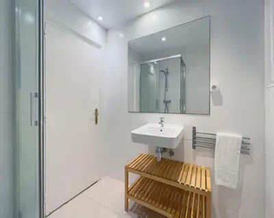 a white bathroom with a sink and a shower at Stay U-nique Apartments Gaudi I in Barcelona