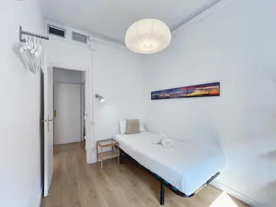 a hospital room with a bed and a painting on the wall at Stay U-nique Apartments Gaudi I in Barcelona