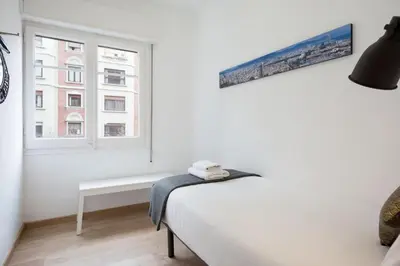 a white bedroom with a bed and a window at Stay U-nique Apartments Gaudi I in Barcelona
