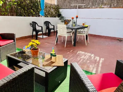 a patio with a table and chairs on a patio at Calm Terrace Barcelona in Barcelona
