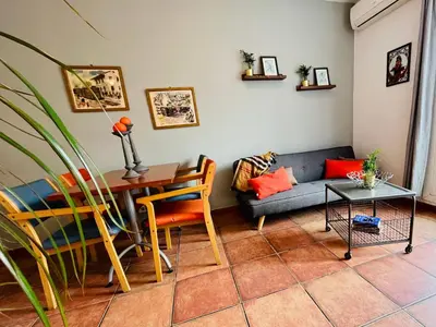 a living room with a couch and a table at Calm Terrace Barcelona in Barcelona