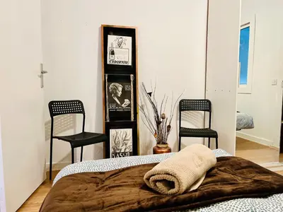 a bedroom with two chairs and a bed with a blanket at Calm Terrace Barcelona in Barcelona