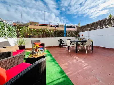 a patio with green grass and a table and chairs at Calm Terrace Barcelona in Barcelona