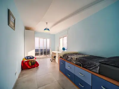 a bedroom with a bed and a desk in it at Villa Elena in Pineda de Mar