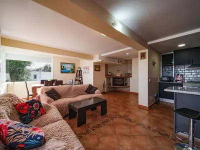 a living room with a couch and a table at Villa Elena in Pineda de Mar