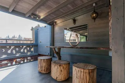 a bar with two stools and a table with a mirror at Stay U-nique Apartment Tamarit II in Barcelona