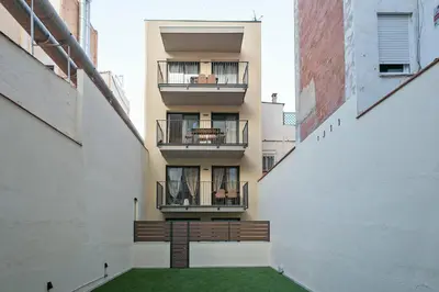 an internal view of an apartment building with a green courtyard at bonito piso cerca del campo de futbol de barcelona in Hospitalet de Llobregat