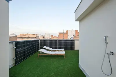a balcony with a bench and a shower at bonito piso cerca del campo de futbol de barcelona in Hospitalet de Llobregat