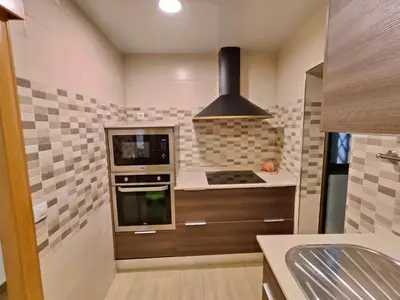 a kitchen with a stove and a microwave at Family apartment Besos 2 in Sant Adria de Besos