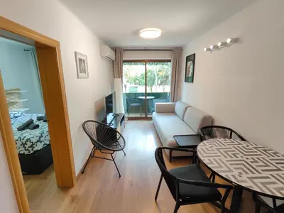 a living room with a couch and a table and chairs at Family apartment Besos 2 in Sant Adria de Besos