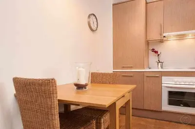 a kitchen with a wooden table with a candle on it at Port I Espectacular apartament con terraza in Barcelona