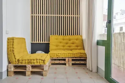a pair of yellow chairs sitting in a room at Canela Homes BARCELONA FONTANA in Barcelona