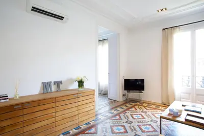 a living room with a dresser and a tv at BarcelonaForRent The Claris Suites I in Barcelona