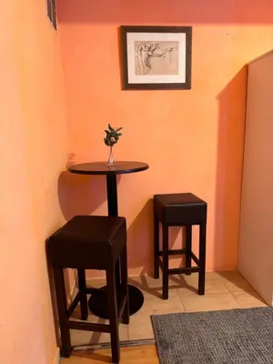 a small table and two stools in a room at Bonita Habitación en chalet in Barcelona
