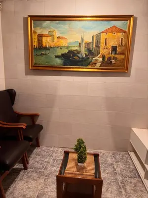 a painting hanging on a wall with a table at Bonita Habitación en chalet in Barcelona