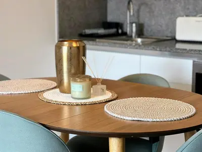 a wooden table with two plates and a candle on it at Loft acogedor cerca de Barcelona in Terrassa