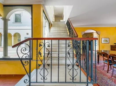 a staircase in a home with yellow walls at Architectural jewel between sea and mountains in Teià