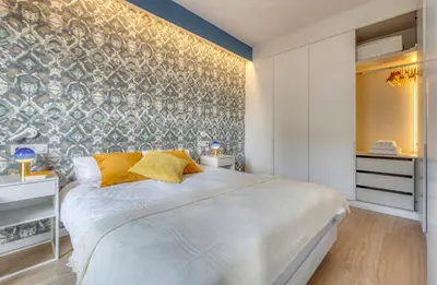 a bedroom with a large white bed and a wall at Stay U-nique Apartments Rambla Catalunya III in Barcelona