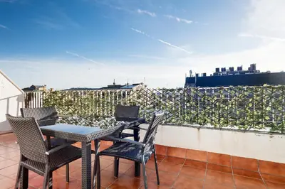 a patio with chairs and a table on a balcony at Stay U-nique Apartments Rambla Catalunya IV in Barcelona
