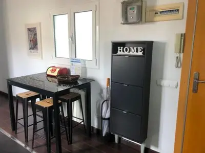 a kitchen with a table and a black refrigerator at Stay U-nique Apartments Rambla Catalunya IV in Barcelona