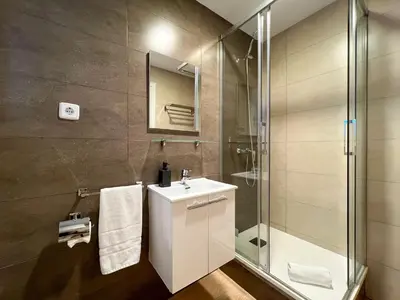 a bathroom with a sink and a glass shower at Stay U-nique Apartments Rambla Catalunya V in Barcelona