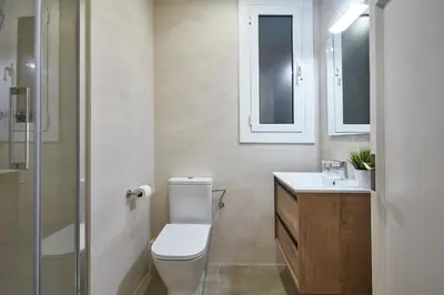 a bathroom with a toilet and a sink and a shower at BBarcelona Central Eixample Flat in Barcelona
