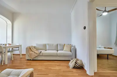 a living room with a couch and a table at BBarcelona Central Eixample Flat in Barcelona