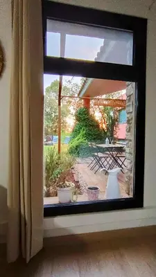 a window with a view of a patio at Casa de invitados in La Torre de Claramunt
