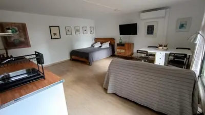 a bedroom with a bed and a desk with a television at Casa de invitados in La Torre de Claramunt
