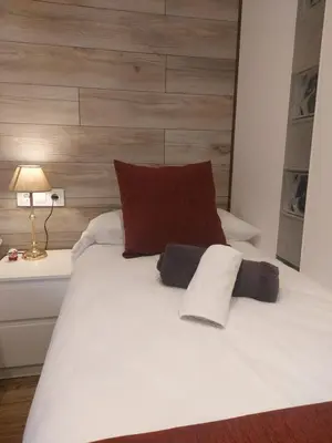 a white bed with two pillows on top of it at Cerca de Barcelona, y entre tres Parques Naturales, casa de 4 habitaciones y 2 baños con piscina, barbacoa y chimenea in San Antonio de Vilamajor