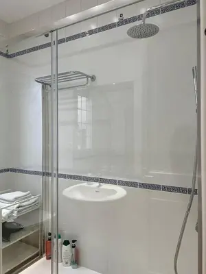 a bathroom with a glass shower with a sink at Ático con encanto, centro, con aparcamiento in Barcelona