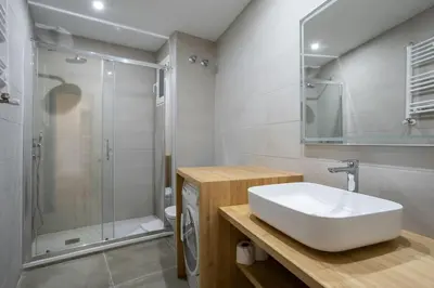a white bathroom with a sink and a shower at Canela Homes BARCELONA PADILLA in Barcelona