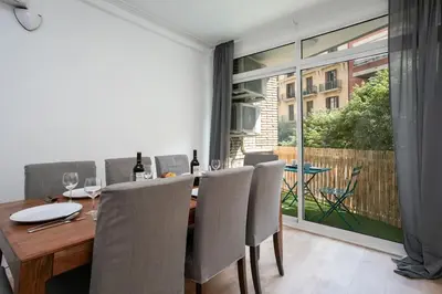 a dining room with a wooden table and chairs at Canela Homes BARCELONA PADILLA in Barcelona