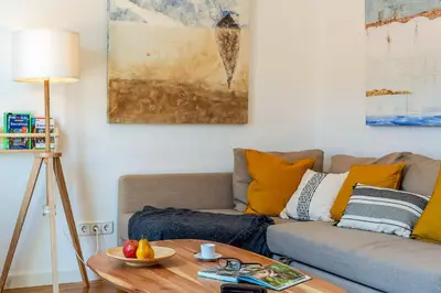 a living room with a couch and a table at Canela Homes BARCELONA FIRA in Barcelona